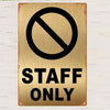 A vintage brass sign with a black circle and diagonal line indicating no staff allowed, below which is the text STAFF ONLY.