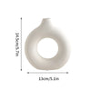 A white ceramic-style vase with a smooth, rounded body and an open circular mouth.