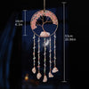 A hanging crystal tree of life sun catcher featuring pink and white floral elements and dangling crystals.