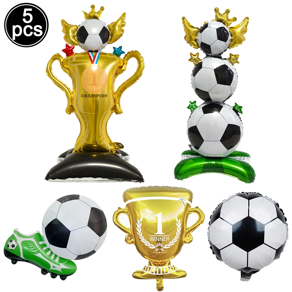 A set of five football-themed party decorations including a golden trophy, soccer balls, and a green soccer shoe.