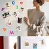 A transparent acrylic photo frame with a magnetic display stand showing various photos.