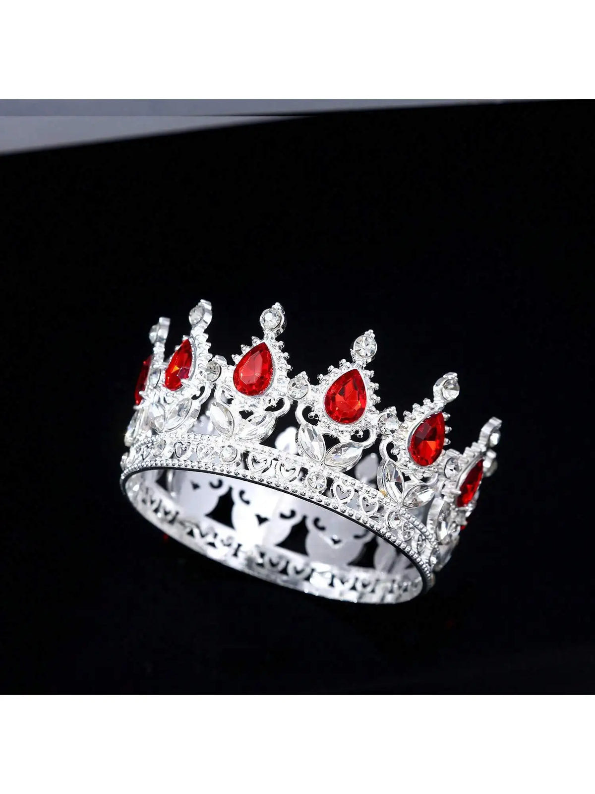 A silver crystal rhinestone crown with red gemstones and intricate detailing.