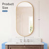Oval wall mirror with a gold metal frame hanging above a marble vanity countertop.