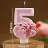 Set of number 5 cake topper candles in pink glitter with a pink bow