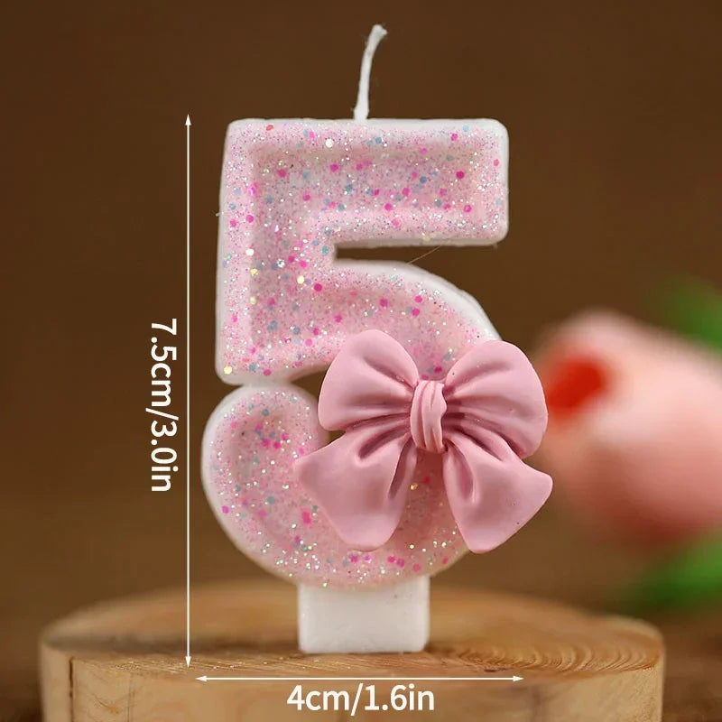 Set of number 5 cake topper candles in pink glitter with a pink bow