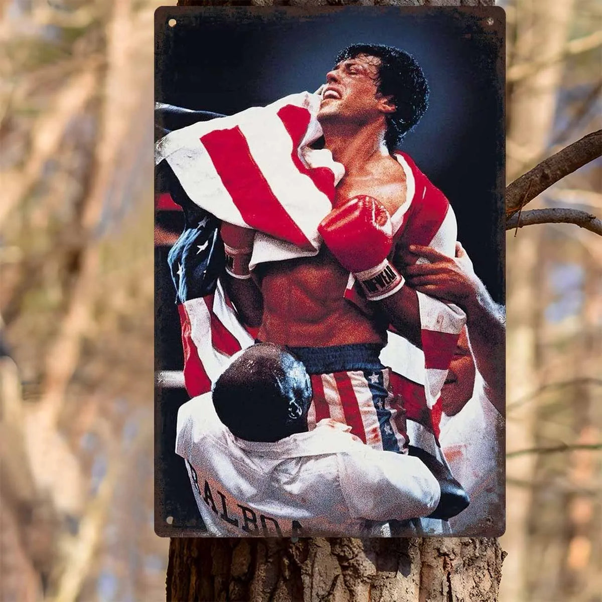 A vintage photograph of a boxing champion celebrating with a striped shirt and gloves, mounted on a metal wall sign.