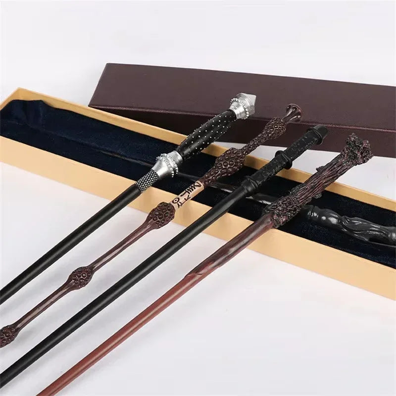 A collection of five character-inspired metal and resin magic wands displayed in a brown box.
