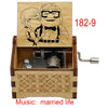 A wooden music box featuring a drawing of a couple and decorative carvings, labeled 182-9.