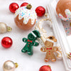 A collection of shatterproof Christmas ball ornaments including red, gold, and green figures on white fabric.
