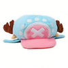 A light blue plush knit cap featuring a face design with white pom-pom accents and a pink cross detail.