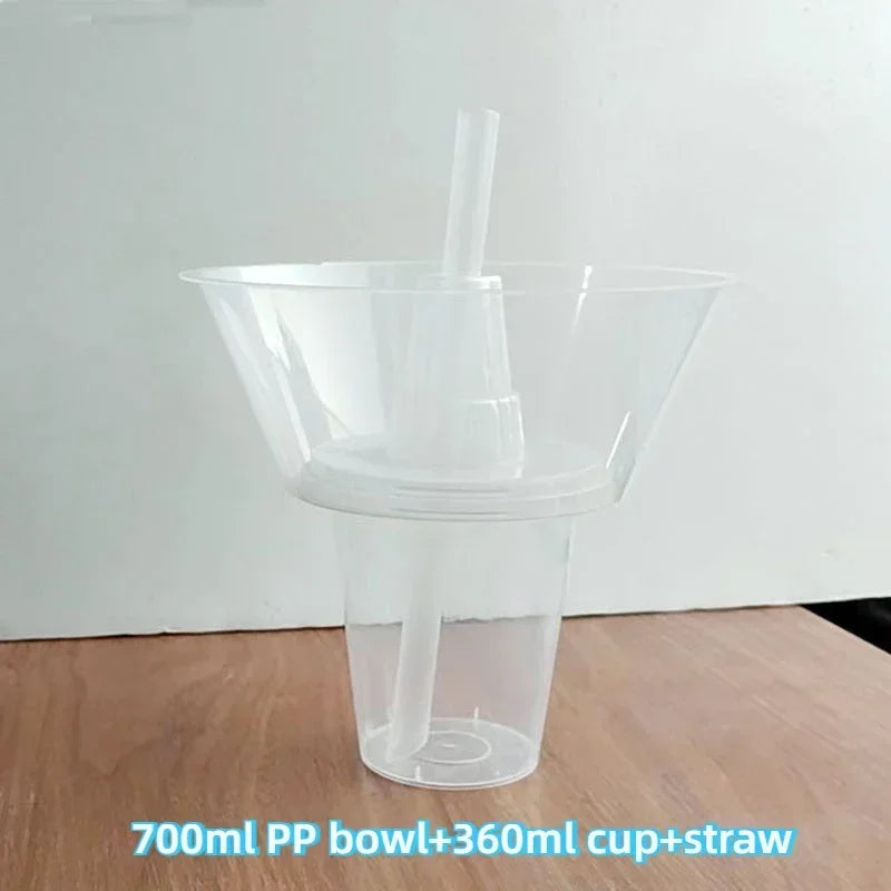 A clear plastic bowl with a cup and straw inside, used for serving drinks or snacks.