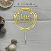 A gold acrylic birthday cake topper with the words Happy Birthday on a circular design.