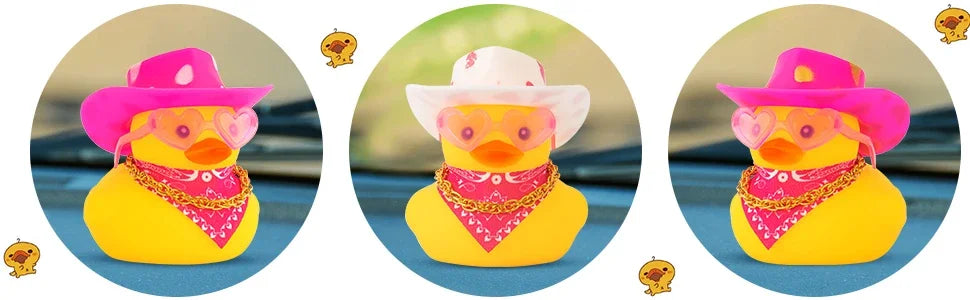 A yellow rubber duck with a pink cowboy hat and a red bandana decoration on a dashboard.