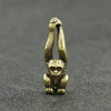 Vintage brass monkey key chain charm with a detailed, sculpted monkey figure.