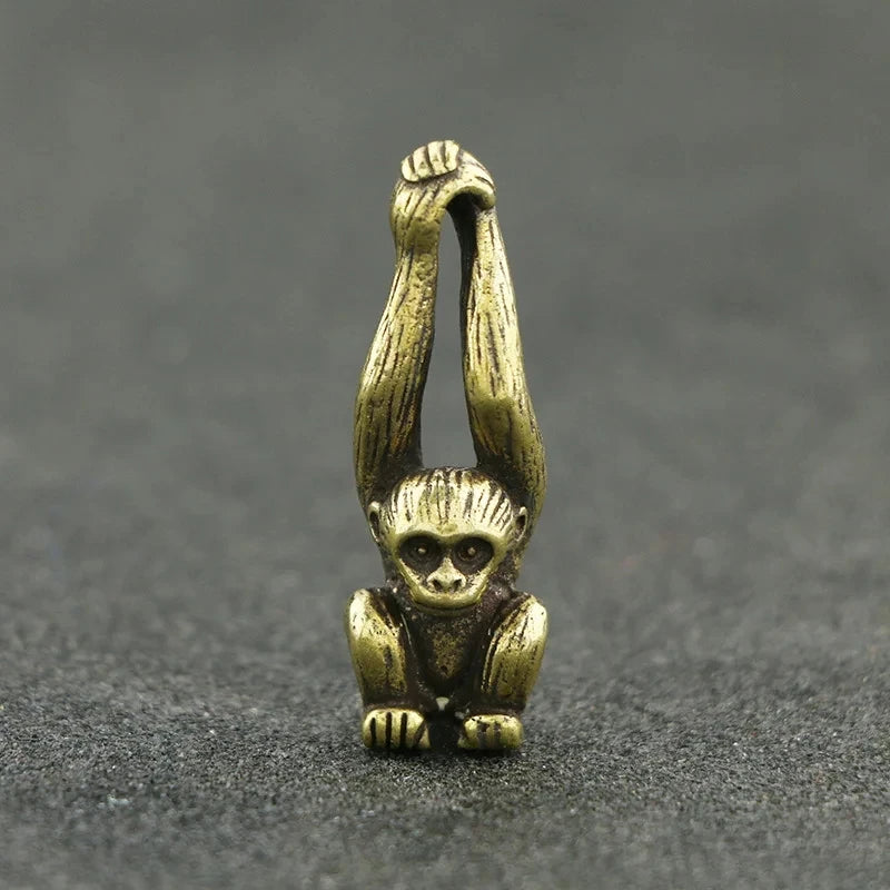 Vintage brass monkey key chain charm with a detailed, sculpted monkey figure.