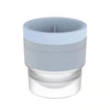 A stackable spherical ice mold for whiskey and cocktails with a clear base and a light gray top.