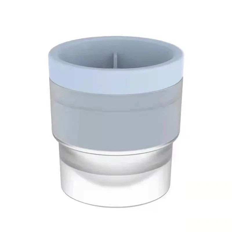A stackable spherical ice mold for whiskey and cocktails with a clear base and a light gray top.