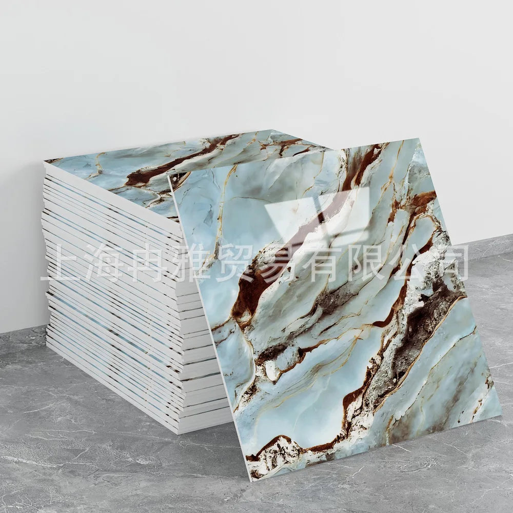 A stack of faux marble 3D self-adhesive wall tiles featuring brown and white veining on a gray background.