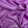 Purple satin fabric draped and folded for sewing or DIY projects