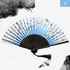 A vintage silk bamboo folding hand fan with black and white floral designs, shown open.