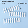 Three white picket fence cake toppers, 2.8cm long, for birthday parties.