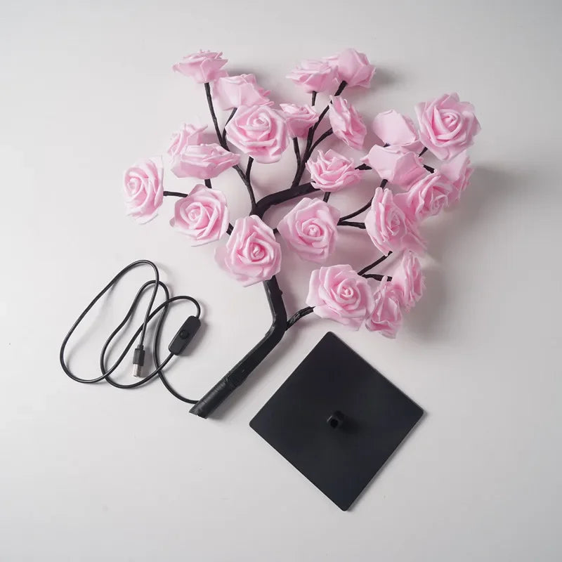 Lampe de table LED en rose avec des roses noires et un fil attaché.