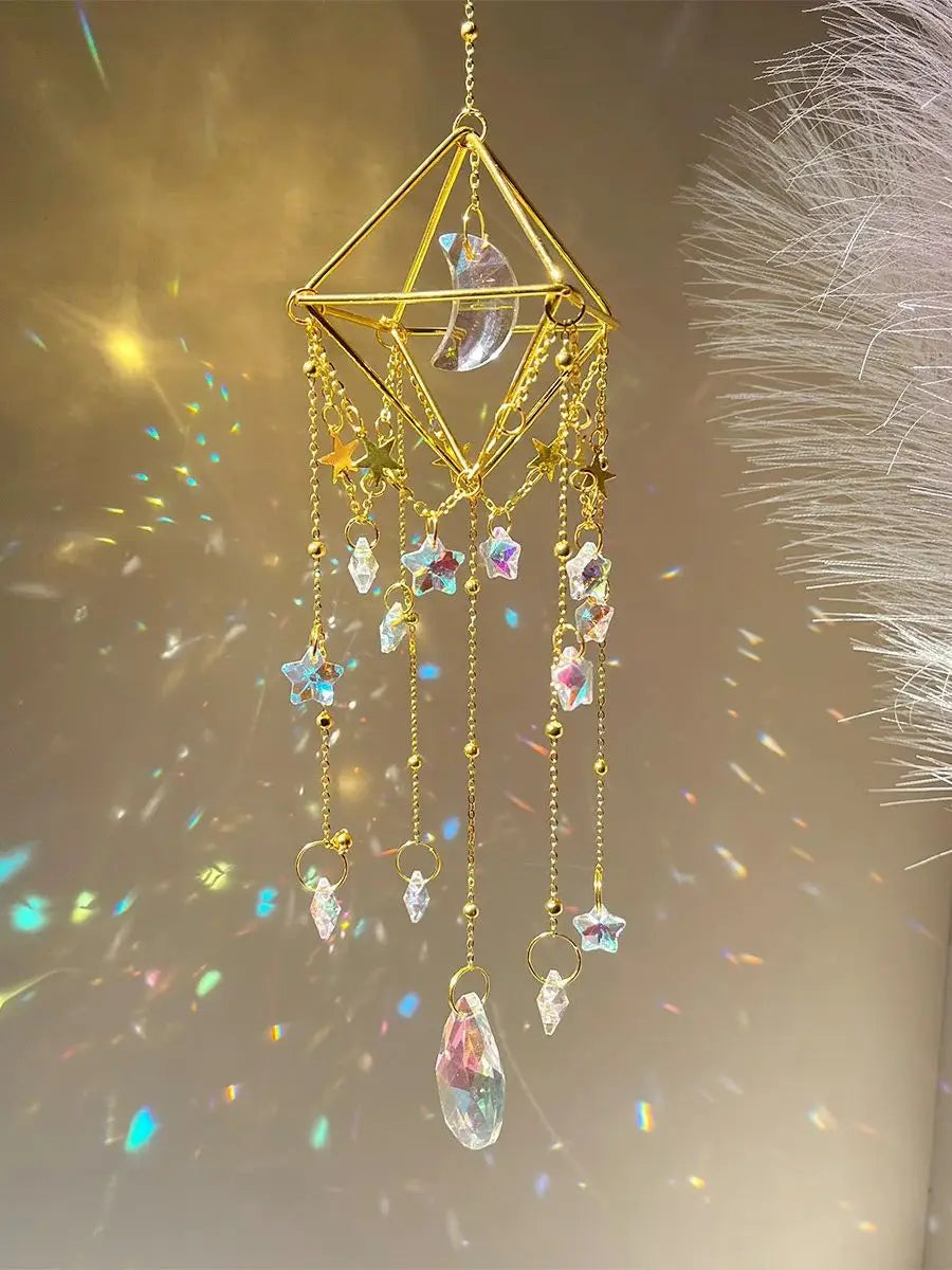 A gold crystal hanging suncatcher decoration featuring a crescent moon and various colored crystals.