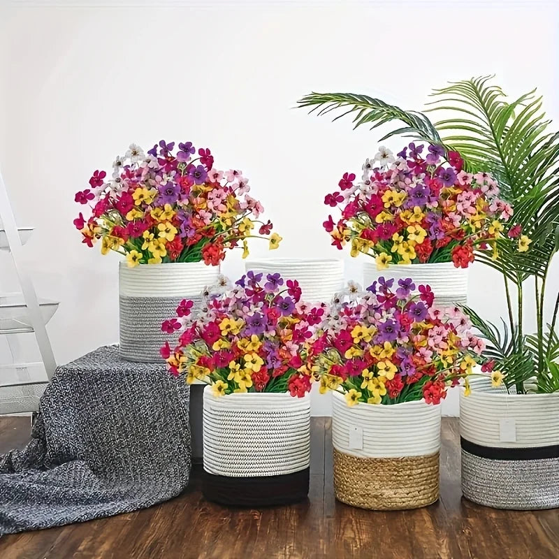 A vibrant arrangement of artificial flowers in various colors like pink, purple, yellow, and green, displayed in white and na