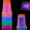 A vertical stack of neon glow plastic party cups in various colors, including pink, blue, green, and purple.