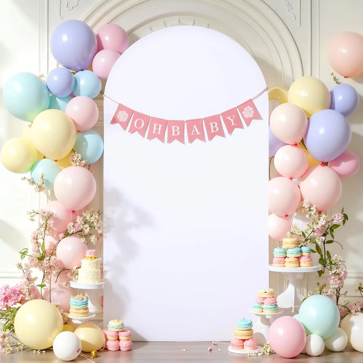 A white arch backdrop decorated with pink bunting and balloons for a baby shower or wedding party.