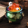A green ceramic jar filled with orange and white silicone Halloween molds for candles and craft projects