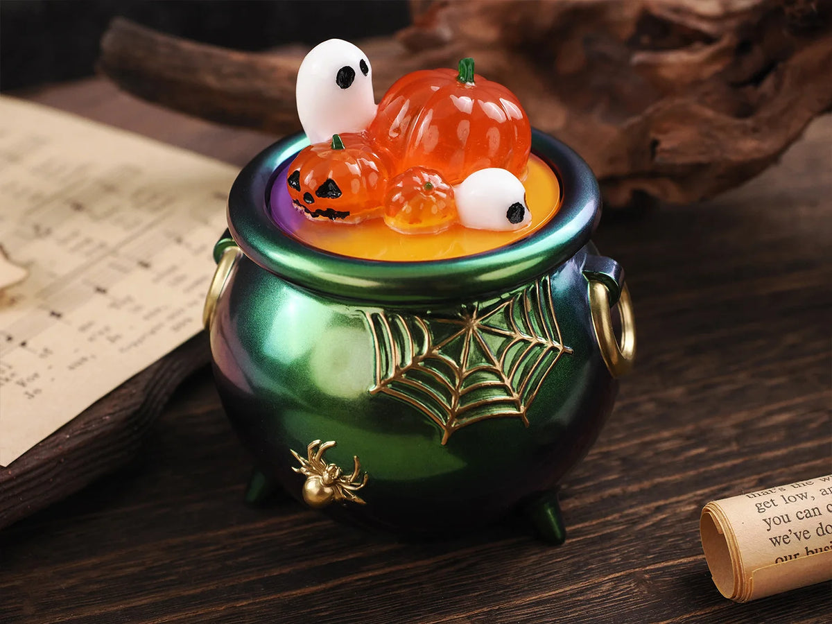 A green ceramic jar filled with orange and white silicone Halloween molds for candles and craft projects