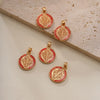 A set of four gold-toned religious pendants featuring the image of Saint Benedict on a red background.