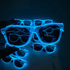 A hand holds a pair of light up EL wire party glasses glowing bright blue against a dark background.