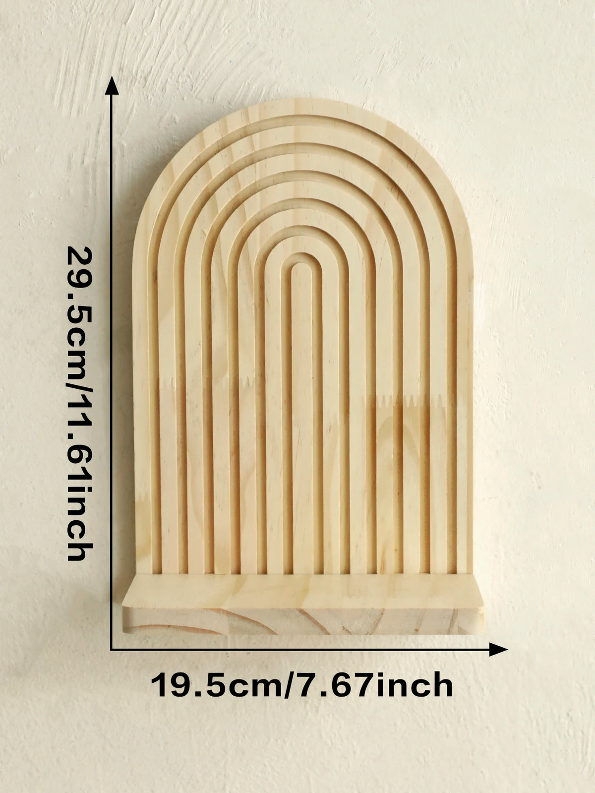 A light wood geometric wall shelf with a rounded arch design, measuring 29.5cm high and 19.5cm wide.