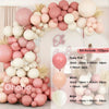 A kit of pink and beige balloons forming a decorative balloon garland arch.
