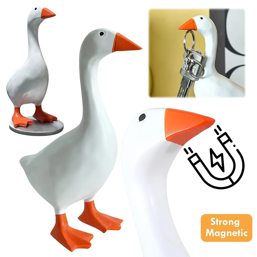 White resin goose figurine with an orange beak and feet, shown alongside a magnetic key holder.