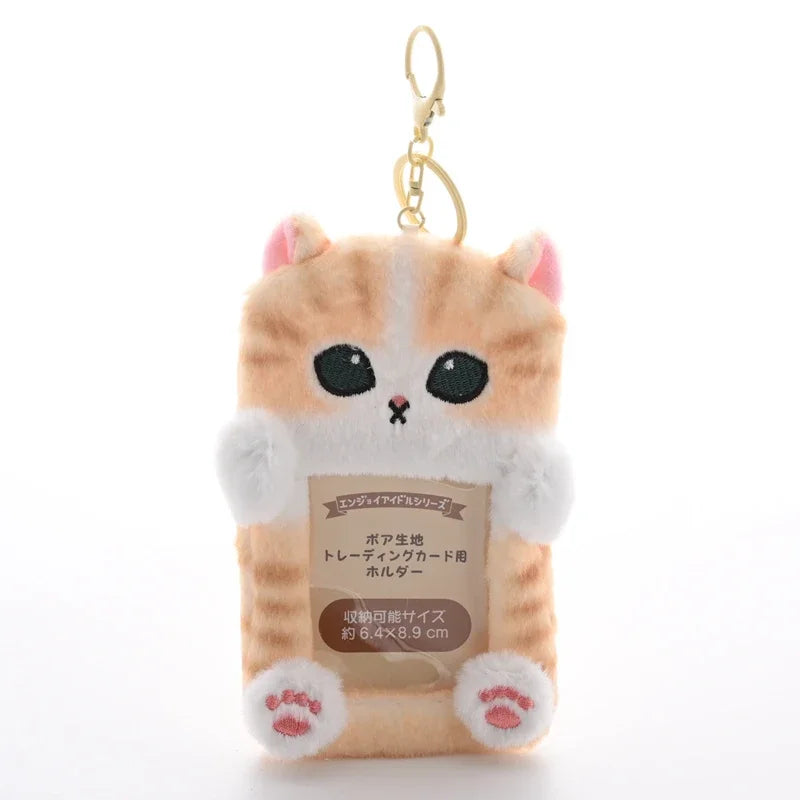 A fluffy orange and white cat keychain featuring a photo card holder.