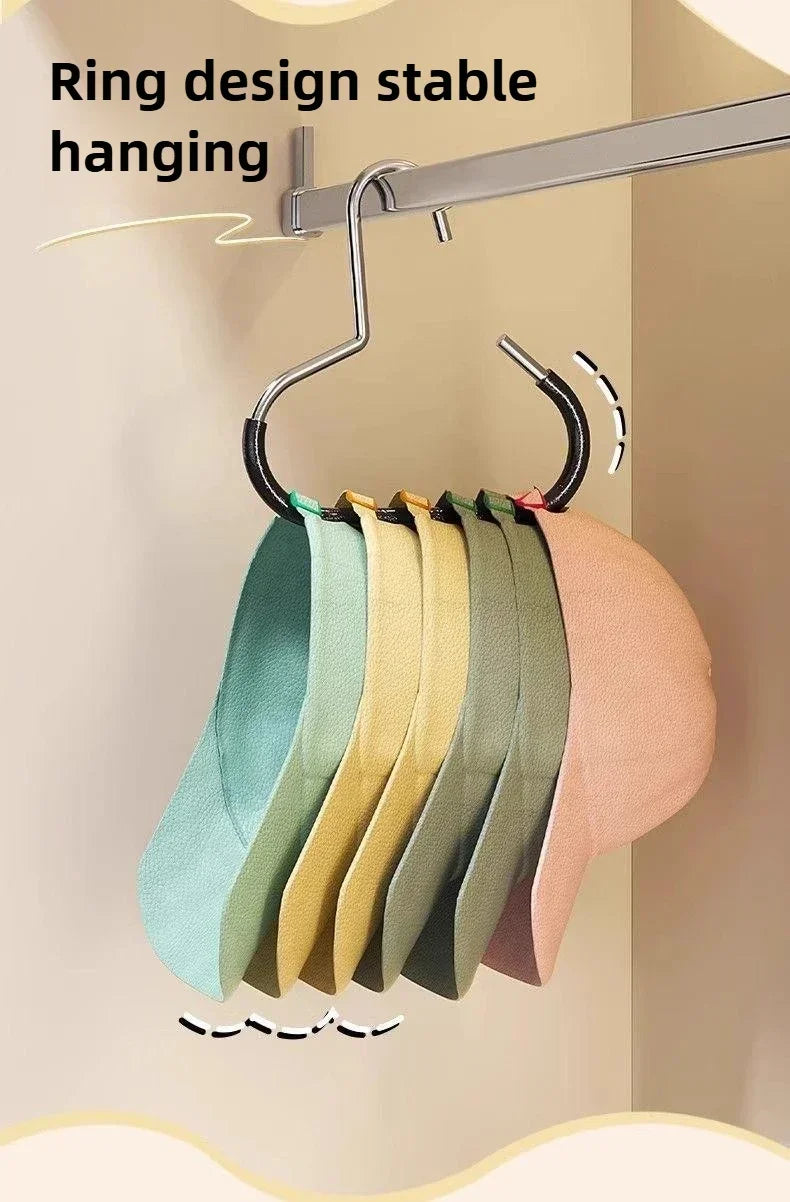 A rack of round multi-purpose closet hooks hanging from a metal bar, displaying various colored hats and scarves.