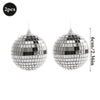 A pair of silver disco mirror balls with a spherical, faceted design.