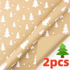 Roll of festive snowflake Christmas wrapping paper featuring white pine trees on brown paper.