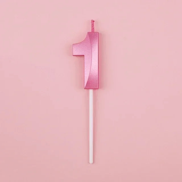 A single pink number candle shaped like the numeral one against a light pink background.