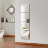 A vertical acrylic mirror wall sticker set displayed on a white wall next to a wooden floor.