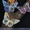 Three iridescent butterfly stickers on a dark branch against a black background.