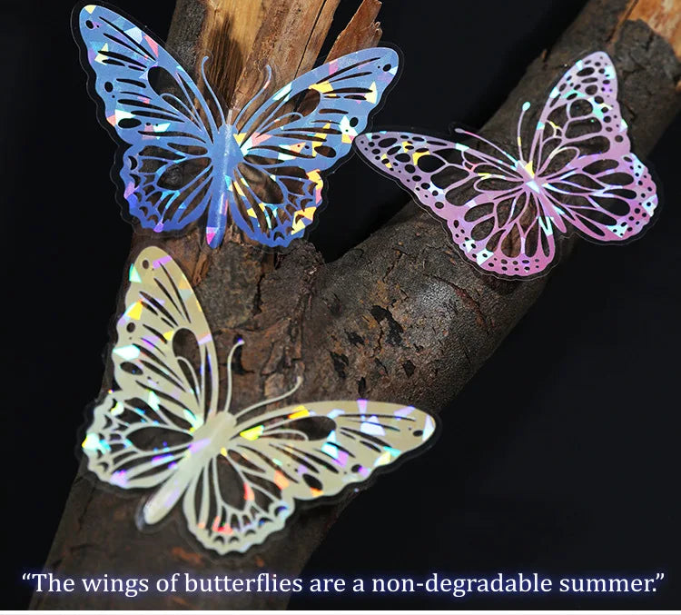 Three iridescent butterfly stickers on a dark branch against a black background.