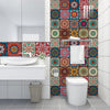 A bathroom vanity with a white sink and a colorful mandala peel and stick tile backsplash.