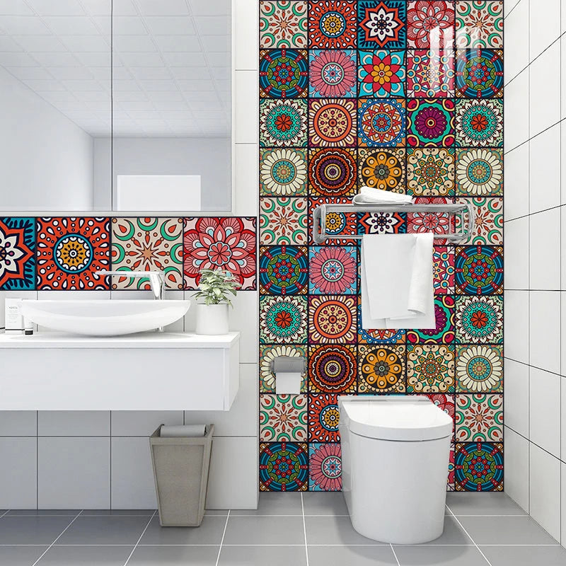 A bathroom vanity with a white sink and a colorful mandala peel and stick tile backsplash.