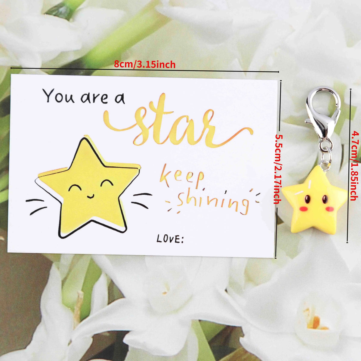 An inspirational card with a yellow star design and a matching gold-colored star keychain.