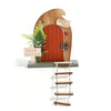 A wooden miniature decoration of a fairy door featuring a tooth box and greenery.
