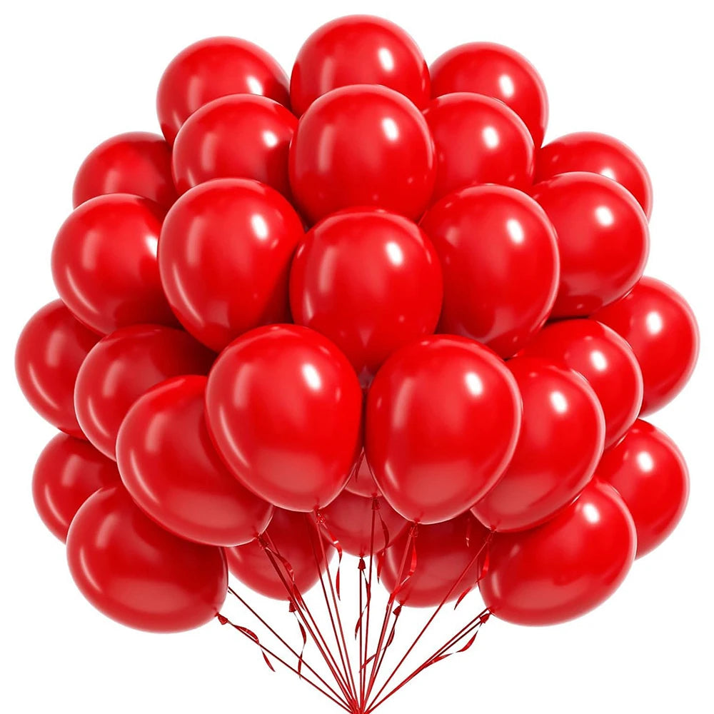 A cluster of bright red round latex balloons tied together.